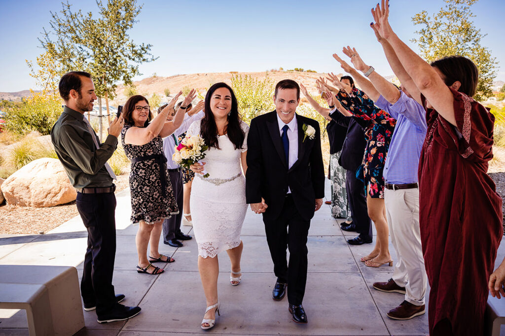 a fanmily and friend moment with the wedding couple as they exit the San Diego Santee Courthouse
